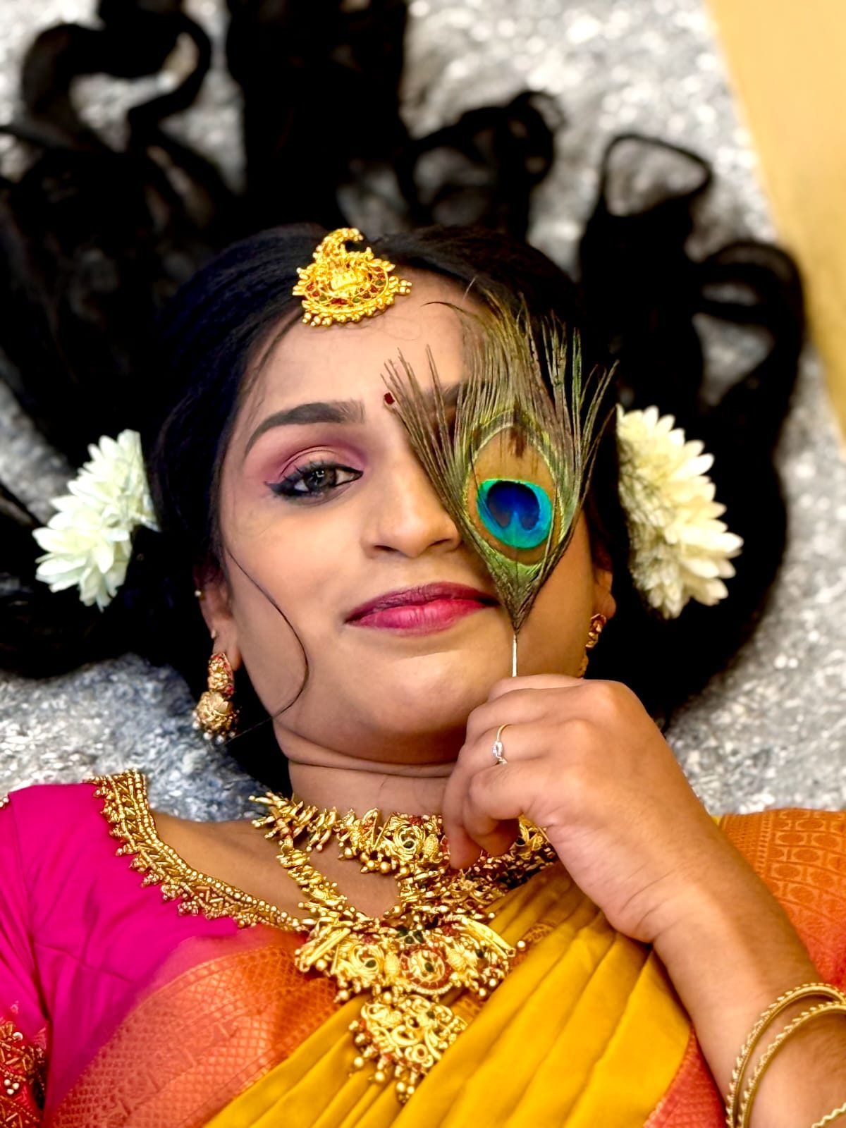 Bridal makeup with peacock feather styling